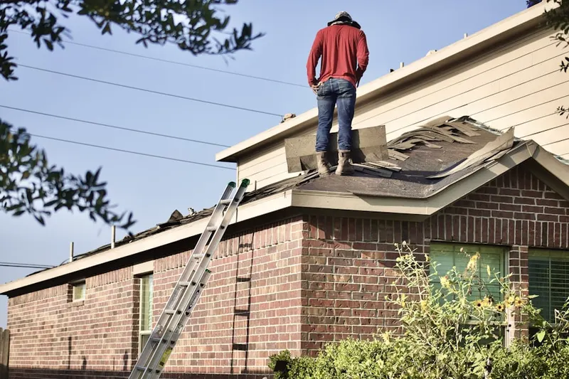 Professional roofer working on a residential roof in Sigmund